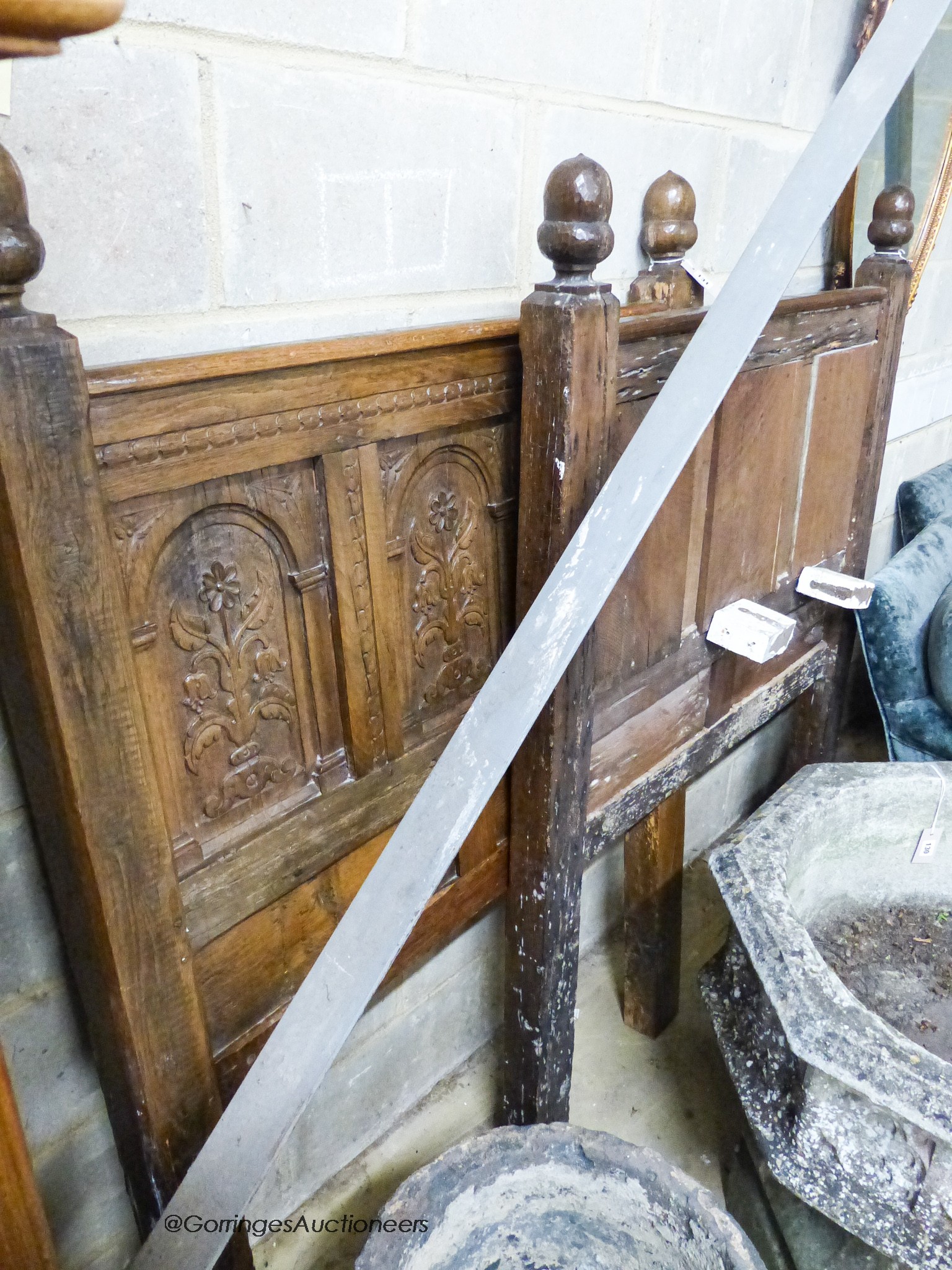 A pair of late 19th century panelled oak single bedsteads with floral carving, width 108cm, height 156cm